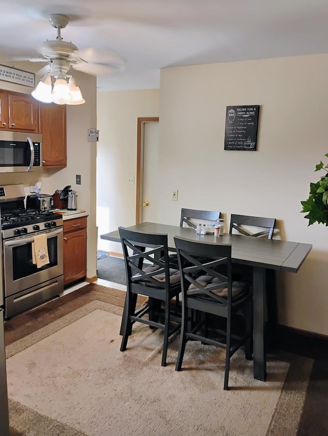 17429 W Chestnut Ln, Gurnee, IL 60031 - kitchen with stainless steel appliances, brown cabinetry, a ceiling fan, and an office area