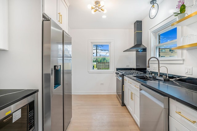 9602 S Troy Ave, Evergreen Park, IL 60805 - kitchen with stainless steel appliances, wall chimney range hood, dark countertops, light wood-type flooring, and white cabinets