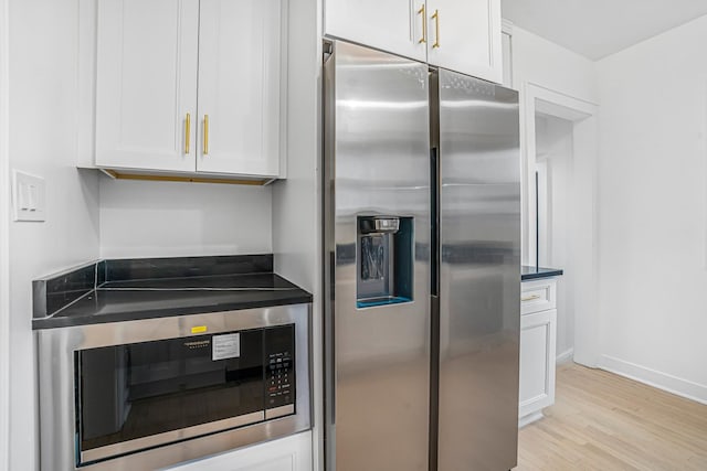 9602 S Troy Ave, Evergreen Park, IL 60805 - kitchen with stainless steel fridge with ice dispenser, built in microwave, white cabinetry, light wood finished floors, and dark countertops