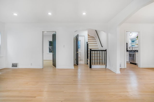 9602 S Troy Ave, Evergreen Park, IL 60805 - unfurnished room with arched walkways, light wood finished floors, stairway, healthy amount of natural light, and recessed lighting