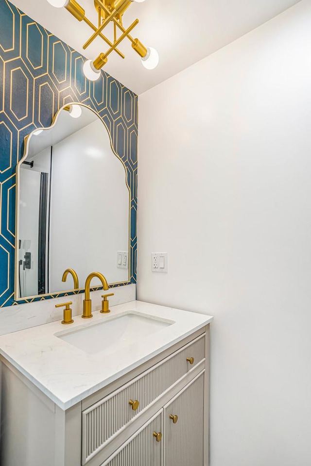 9602 S Troy Ave, Evergreen Park, IL 60805 - bathroom featuring vanity, a chandelier, and wallpapered walls