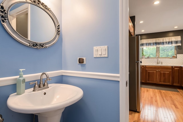 210 Des Plaines Ave Unit B, Forest Park, IL 60130 - bathroom with a sink, decorative backsplash, recessed lighting, and wood finished floors