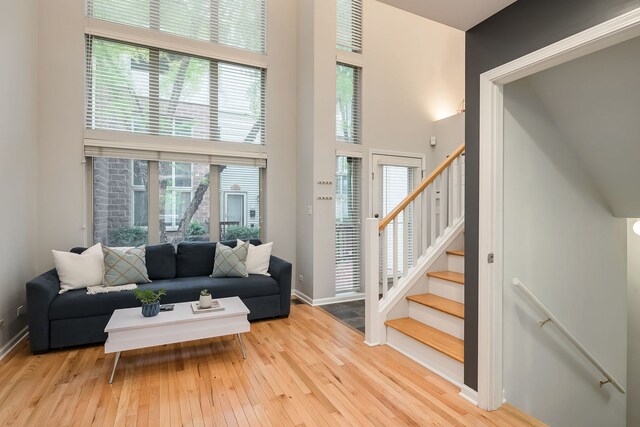 210 Des Plaines Ave Unit B, Forest Park, IL 60130 - living area with a high ceiling, hardwood / wood-style flooring, stairway, and baseboards