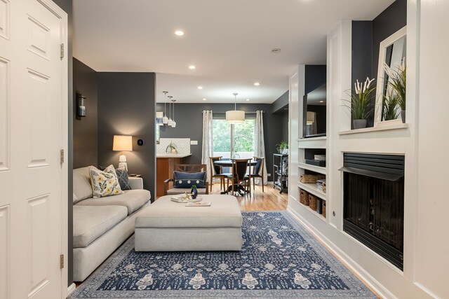 210 Des Plaines Ave Unit B, Forest Park, IL 60130 - living room featuring wood finished floors, built in features, recessed lighting, and a fireplace with raised hearth