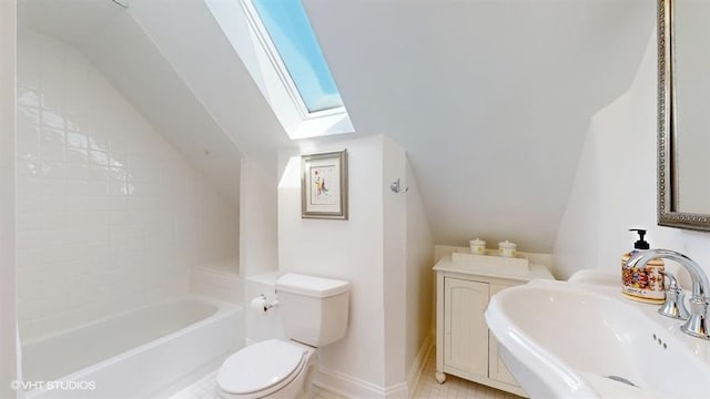 5247 Greenwood St, Skokie, IL 60077 - bathroom with toilet, vaulted ceiling, a skylight, a sink, and baseboards