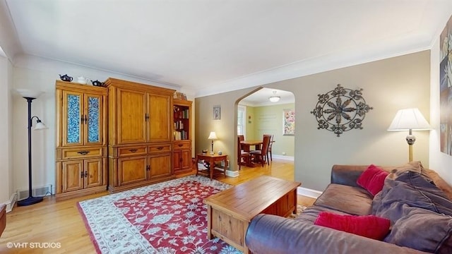 5247 Greenwood St, Skokie, IL 60077 - living room with arched walkways, light wood-style floors, crown molding, and baseboards