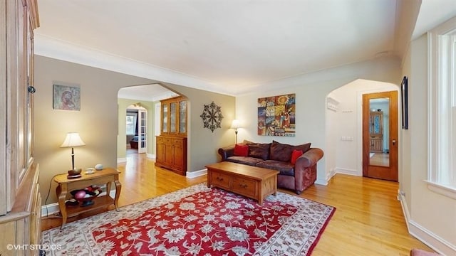 5247 Greenwood St, Skokie, IL 60077 - living area with arched walkways, light wood-style floors, and baseboards