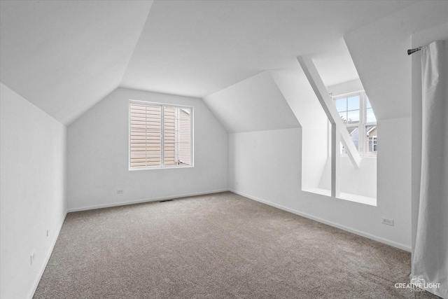 1632 Victoria Park Cir, Aurora, IL 60504 - additional living space featuring carpet floors, vaulted ceiling, and baseboards