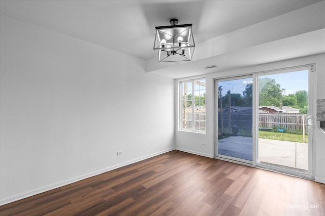 1632 Victoria Park Cir, Aurora, IL 60504 - unfurnished dining area featuring wood finished floors, a chandelier, plenty of natural light, and baseboards