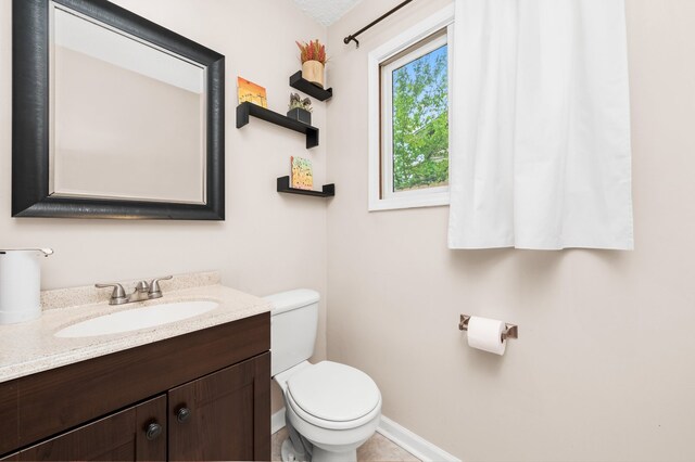 5401 W Arlington Dr, Hanover Park, IL 60133 - bathroom featuring toilet, vanity, and baseboards