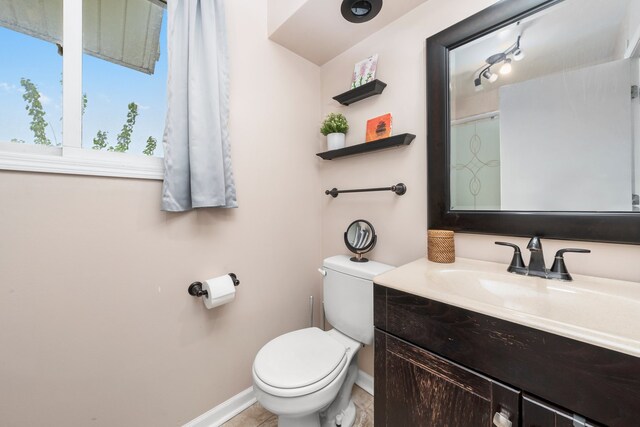 5401 W Arlington Dr, Hanover Park, IL 60133 - bathroom featuring toilet, vanity, and baseboards