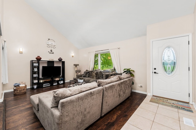 5401 W Arlington Dr, Hanover Park, IL 60133 - living room featuring high vaulted ceiling, wood finished floors, and baseboards