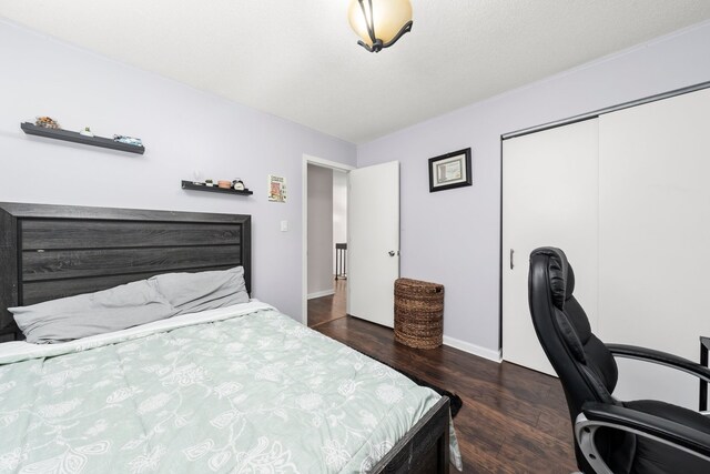 5401 W Arlington Dr, Hanover Park, IL 60133 - bedroom featuring wood finished floors, a closet, a desk, and baseboards