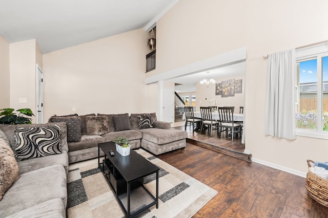 5401 W Arlington Dr, Hanover Park, IL 60133 - living room featuring a chandelier, high vaulted ceiling, wood finished floors, baseboards, and stairway