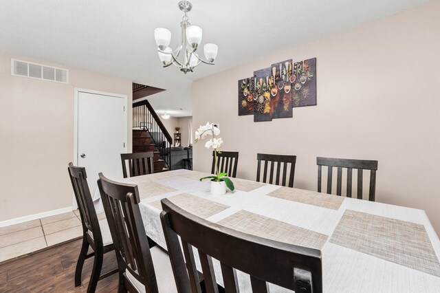 5401 W Arlington Dr, Hanover Park, IL 60133 - dining room with a chandelier, dark wood finished floors, baseboards, and stairway