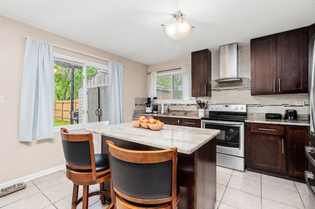 5401 W Arlington Dr, Hanover Park, IL 60133 - kitchen with electric stove, wall chimney exhaust hood, light tile patterned flooring, and dark brown cabinets