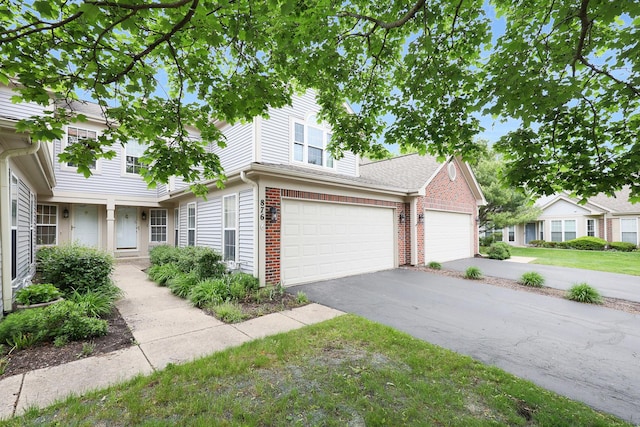 876 Dandridge Ct, Elgin, IL 60120 - view of front facade with brick siding and driveway