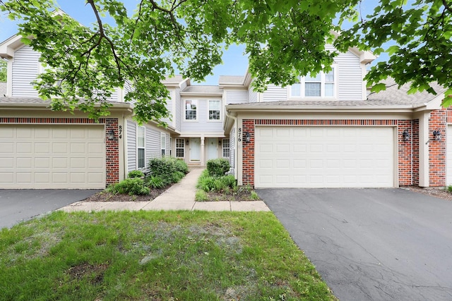 876 Dandridge Ct, Elgin, IL 60120 - view of front of home with driveway, brick siding, an attached garage, and roof with shingles