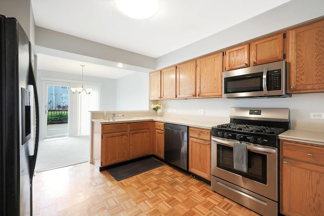 876 Dandridge Ct, Elgin, IL 60120 - kitchen featuring stainless steel appliances, a peninsula, light countertops, and a sink