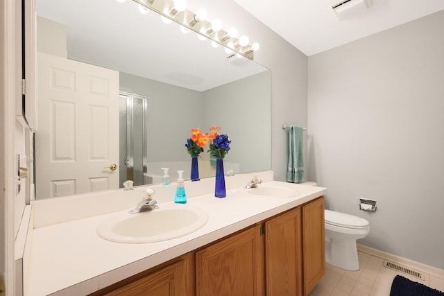 876 Dandridge Ct, Elgin, IL 60120 - bathroom featuring double vanity, toilet, a shower with shower door, tile patterned floors, and baseboards
