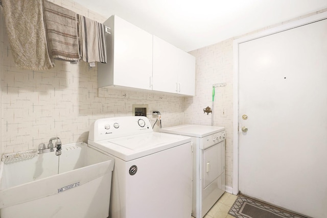 876 Dandridge Ct, Elgin, IL 60120 - washroom featuring washing machine and clothes dryer, cabinet space, and light tile patterned floors