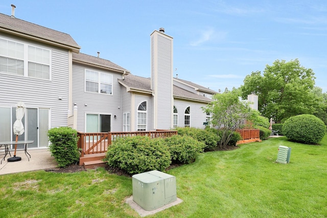 876 Dandridge Ct, Elgin, IL 60120 - rear view of property with a yard, a wooden deck, and a chimney