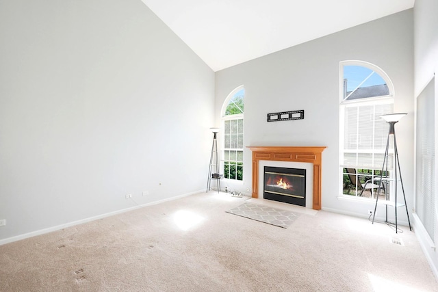 876 Dandridge Ct, Elgin, IL 60120 - unfurnished living room with high vaulted ceiling, carpet flooring, baseboards, and a fireplace with flush hearth