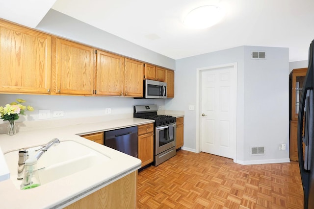 876 Dandridge Ct, Elgin, IL 60120 - kitchen featuring appliances with stainless steel finishes, light countertops, baseboards, and a sink