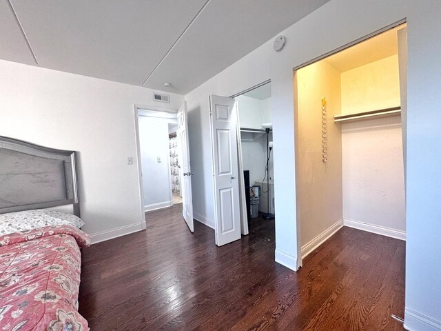 735 N Swift Rd Unit 102, Addison, IL 60101 - bedroom featuring wood finished floors, a closet, baseboards, and a spacious closet