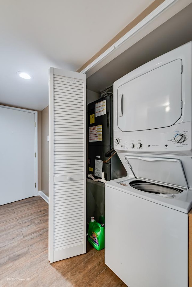 6525 Main St Unit 204, Downers Grove, IL 60516 - washroom featuring stacked washer / drying machine, light wood-type flooring, and recessed lighting