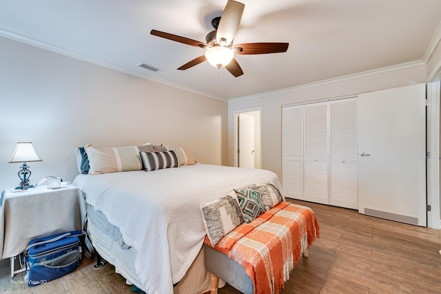 6525 Main St Unit 204, Downers Grove, IL 60516 - bedroom featuring crown molding, wood finished floors, a closet, and ceiling fan