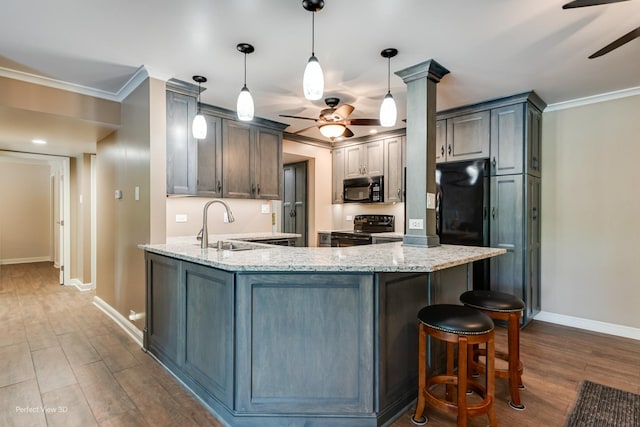 6525 Main St Unit 204, Downers Grove, IL 60516 - kitchen with a ceiling fan, black appliances, crown molding, a peninsula, and dark wood-type flooring