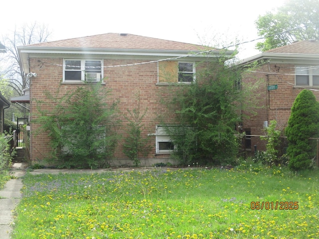 view of side of home with brick siding