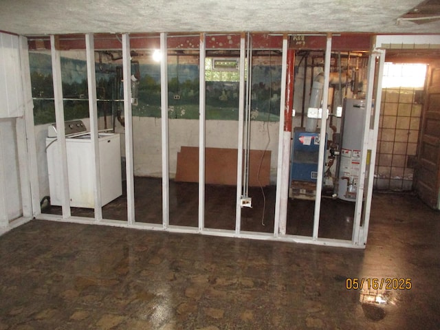 below grade area featuring gas water heater, washing machine and dryer, and a heating unit