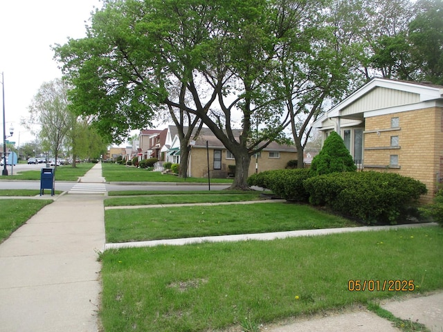 view of community featuring a yard and a residential view