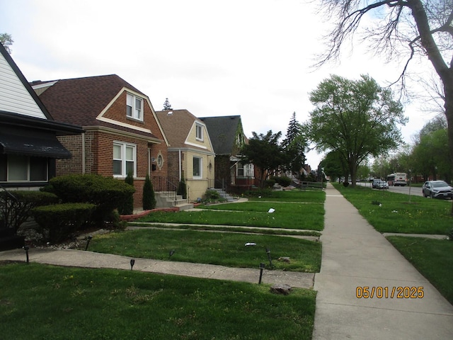 view of front of property featuring brick siding and a front lawn