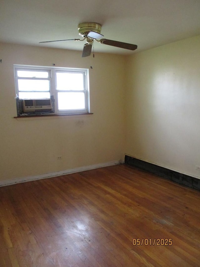 unfurnished room featuring wood finished floors, ceiling fan, cooling unit, and baseboards