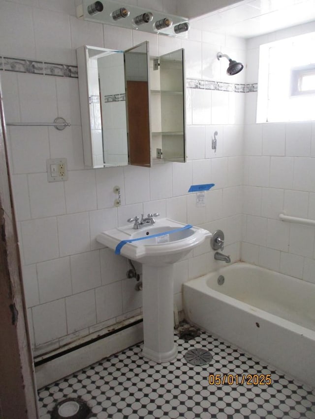 bathroom with tile walls, shower / tub combination, tile patterned floors, and backsplash