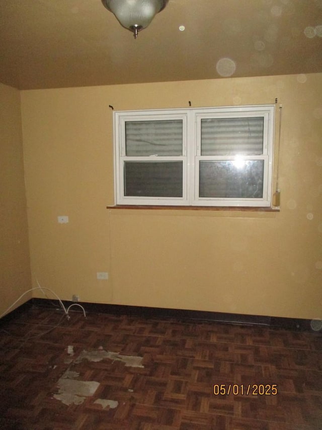 spare room featuring baseboards