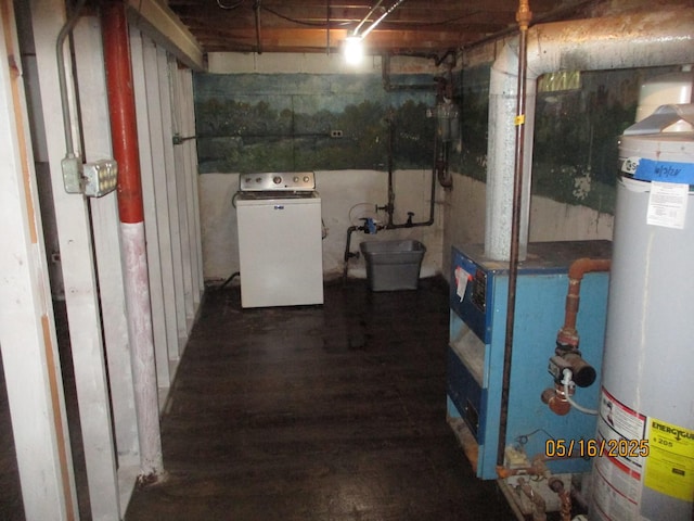 unfinished below grade area with washer / clothes dryer, water heater, and wood finished floors
