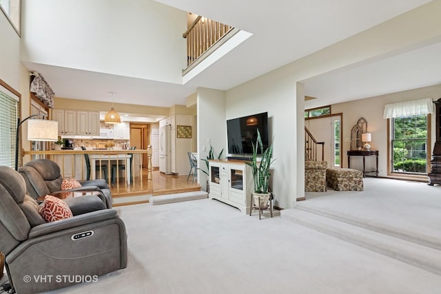 1965 Jamestown Ln, Elgin, IL 60123 - living area with stairway, light colored carpet, and a towering ceiling