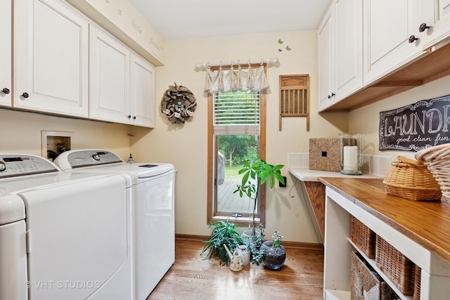 1965 Jamestown Ln, Elgin, IL 60123 - washroom with washing machine and clothes dryer, light wood-style flooring, and cabinet space