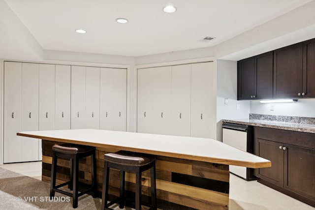 1965 Jamestown Ln, Elgin, IL 60123 - kitchen featuring a kitchen breakfast bar, light countertops, dark brown cabinetry, recessed lighting, and dishwasher