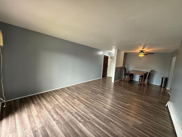 605 Hill Dr Unit 206, Hoffman Estates, IL 60169 - unfurnished living room with ceiling fan, a baseboard heating unit, dark wood finished floors, and baseboards