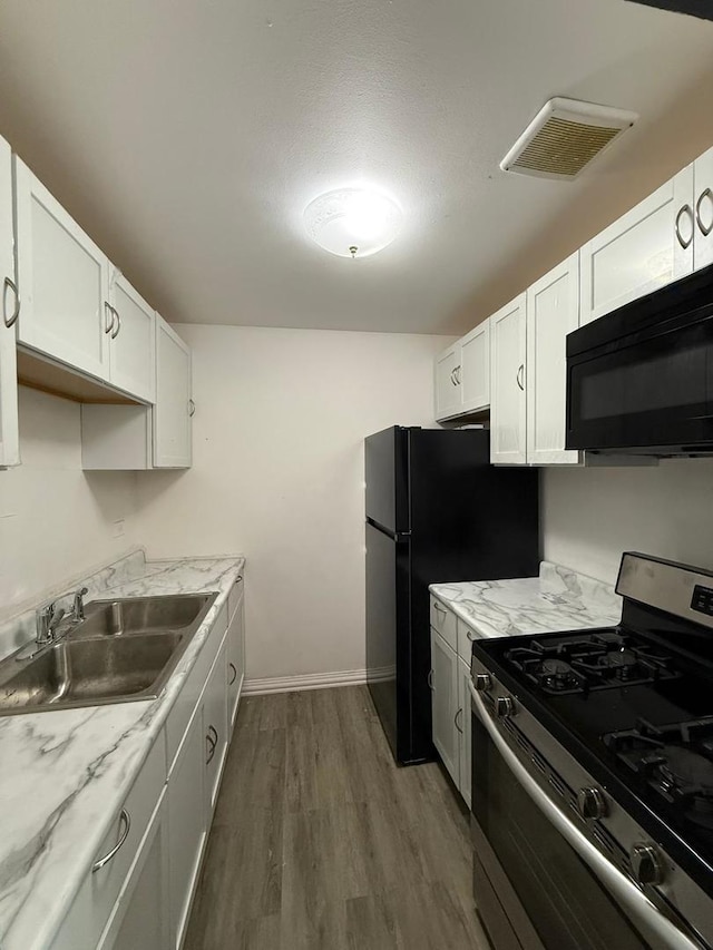 605 Hill Dr Unit 206, Hoffman Estates, IL 60169 - kitchen with stainless steel gas range, black microwave, a sink, dark wood-style flooring, and white cabinets