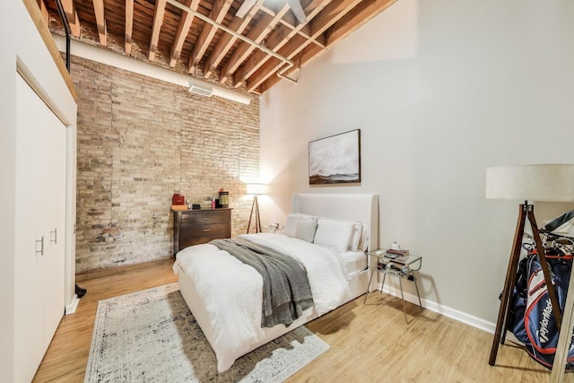 525 N Halsted St Unit 409, Chicago, IL 60642 - bedroom with brick wall and wood finished floors