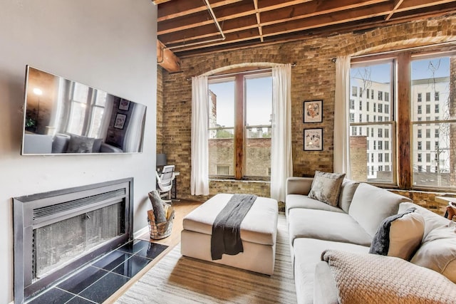 525 N Halsted St Unit 409, Chicago, IL 60642 - living area with plenty of natural light, a fireplace with flush hearth, and beam ceiling