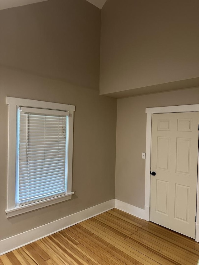 empty room with baseboards and light wood-style floors