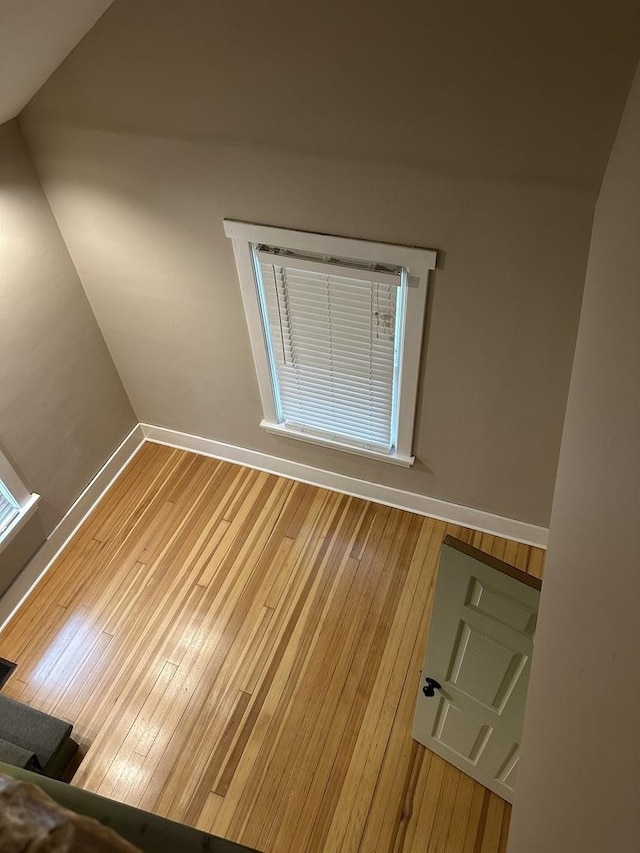 empty room with wood finished floors and baseboards