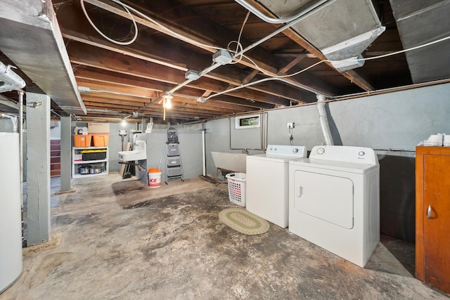 basement with washer and clothes dryer and a sink